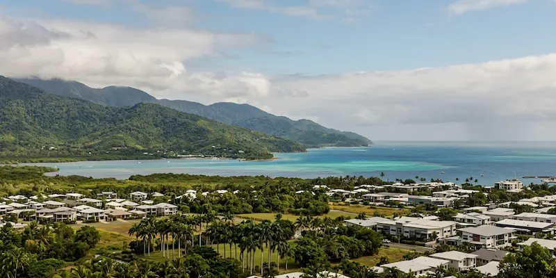 Aerial view of Cairns coastline and rainforest hills showing the tropical climate that affects carpet drying times